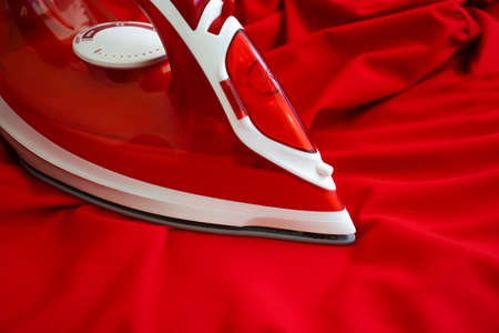 electric iron red cloth backgroundの写真素材