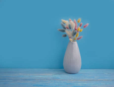 fluffy flower in a vase on a wooden backgroundの写真素材