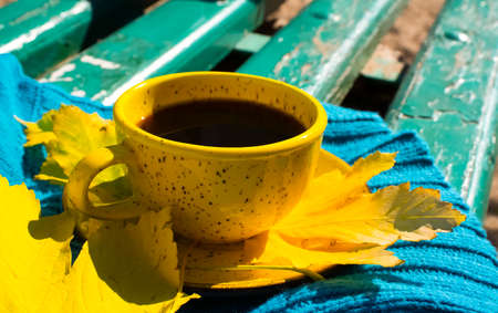cup of coffee, autumn maple leaf, scarf on a wooden background,の写真素材