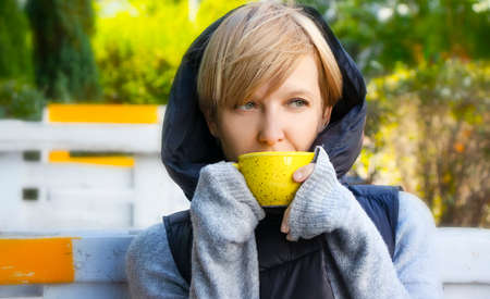 pensive woman with coffee in a cafe on the street portrait