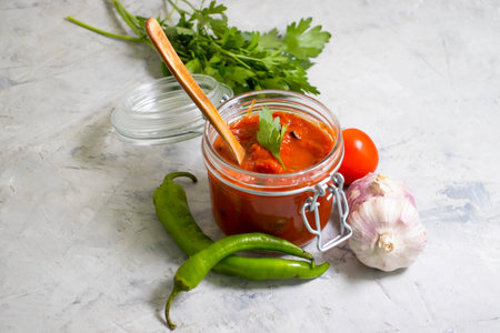 homemade tomato sauce on a concrete background