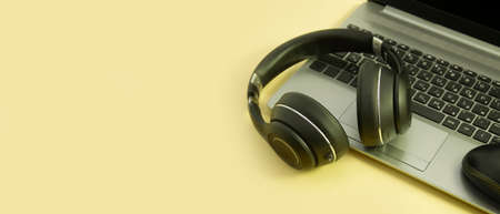 laptop, headphones on a colored background