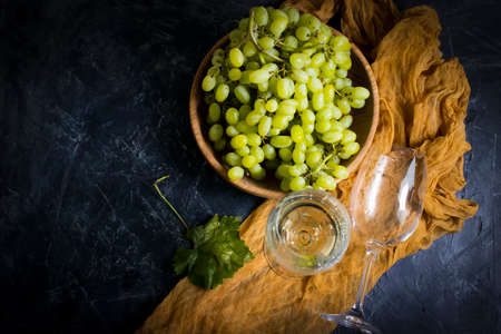 wine, grapes glass on concrete background