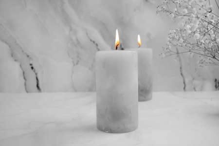 candle, gypsophila flower on a concrete backgroundの写真素材