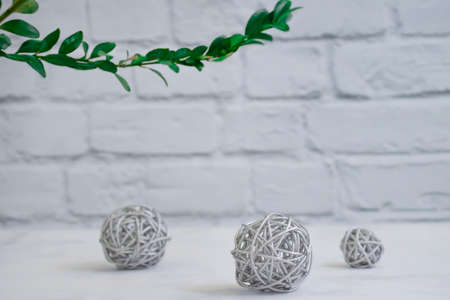 rattan ball, branch on a brick background