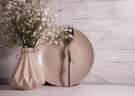 empty plate, vases gypsophila flower on wooden backgroundの写真素材