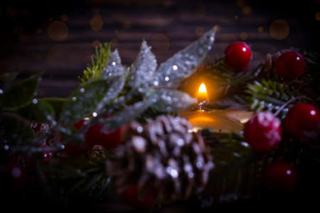 festive christmas background, candle, christmas tree branchの写真素材