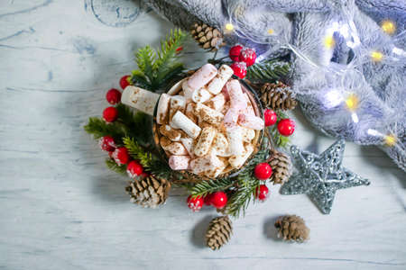 cup with marshmallows, garland festive background
