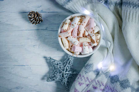 cup with marshmallows, garland festive backgroundの写真素材