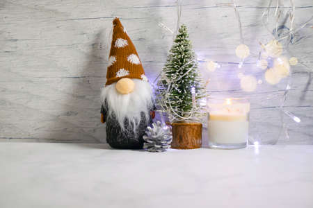 decorative christmas tree, gnome on wooden backgroundの写真素材