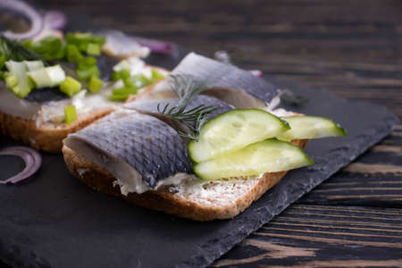 herring sandwich blue onion on wooden backgroundの写真素材