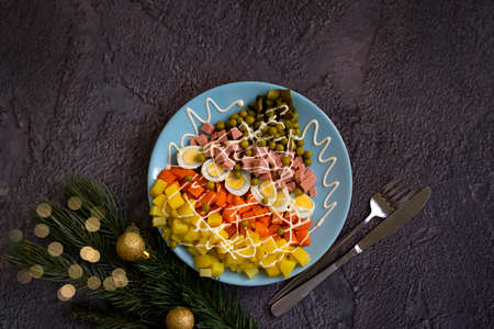 Olivier salad in a plate festive backgroundの写真素材