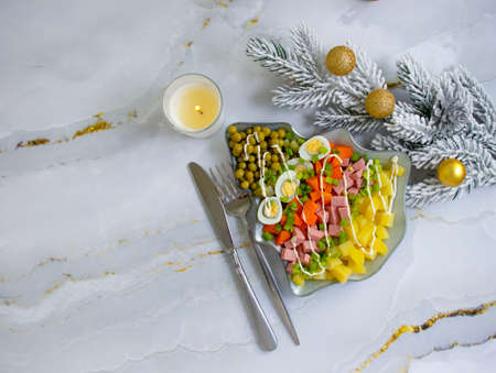 Olivier salad in a plate festive backgroundの写真素材