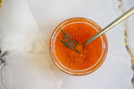 jar with red caviar on a marble backgroundの写真素材