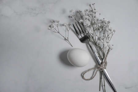 fork, egg gypsophila flower festive background