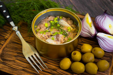 canned fish in a jar, dill on a wooden backgroundの写真素材