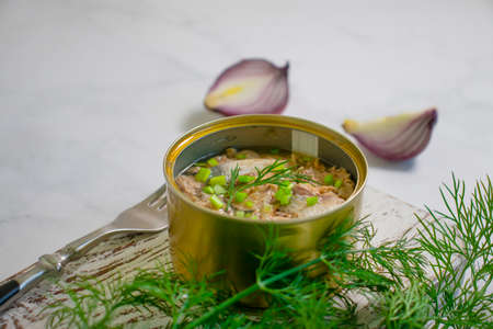 canned fish in a jar, dill on a wooden backgroundの写真素材
