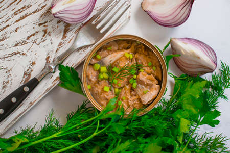 canned fish in a jar, dill on a wooden backgroundの写真素材