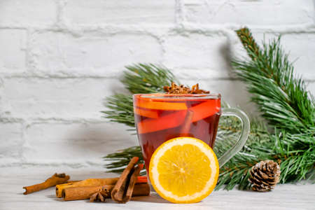 mulled wine in a glass cup on a wooden backgroundの写真素材