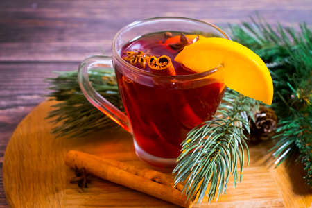 glass with mulled wine, lemon on wooden backgroundの写真素材