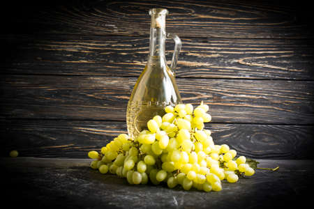 wine, fresh grapes on old backgroundの写真素材