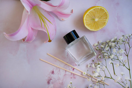 bottle of home fragrance orange, gypsophila flower
