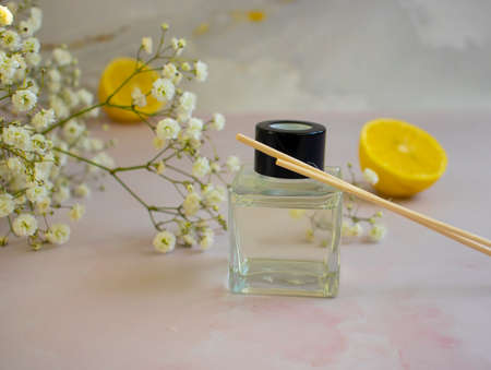 bottle of home fragrance orange, gypsophila flower