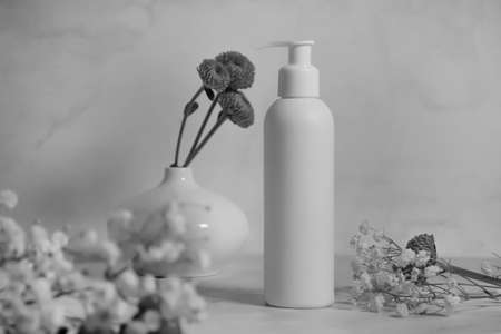 bottle with flower soap on a light backgroundの写真素材