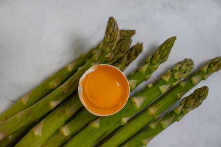 asparagus, raw egg on old backgroundの写真素材