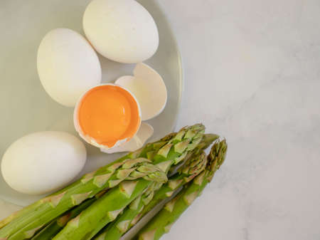 asparagus, raw egg on old backgroundの写真素材