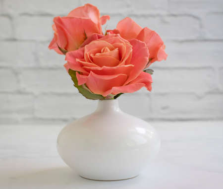 rose flower in vase on old backgroundの写真素材