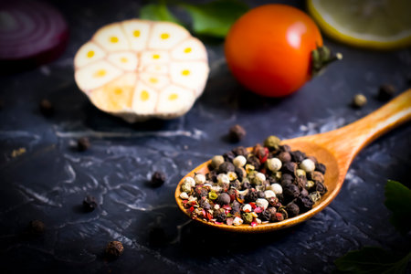 spice pepper in a spoon on a dark backgroundの写真素材