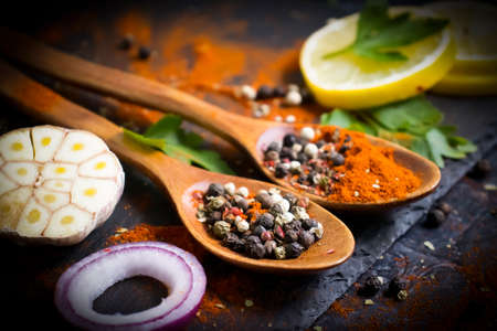 spice pepper in a spoon on a dark background