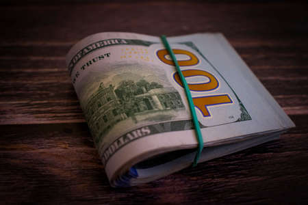 dollars twisted on wooden backgroundの写真素材