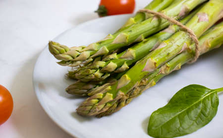 Fresh different vegetables, empty plateの写真素材