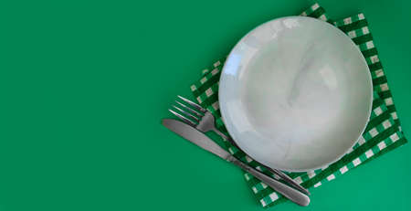 Empty Plate, Fork, Knife on a Colored Backgroundの写真素材