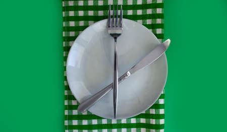 Empty Plate, Fork, Knife on a Colored Backgroundの写真素材