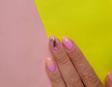 female hand beautiful manicure on a colored background