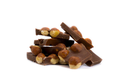 Chocolate pieces with hazelnuts on a white background