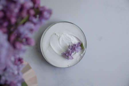 cream cosmetic lilac flower background