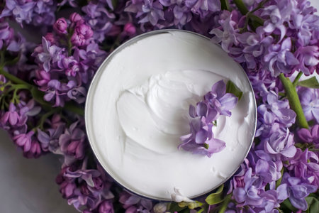 cream cosmetic lilac flower backgroundの写真素材