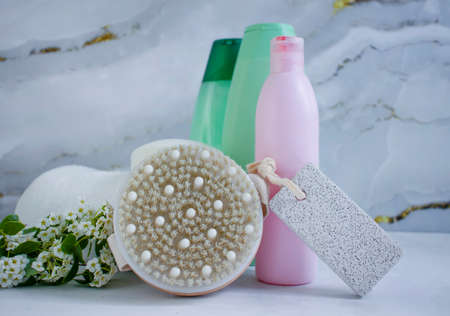 pumice for feet, towel, flower, soap on a light background