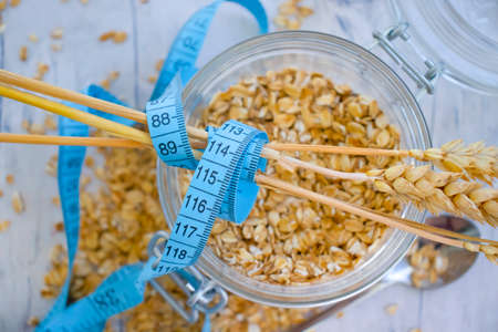 Dry oatmeal measuring tape on old background