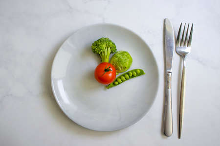 Vegetables on a plate, broccoli, cabbage, tomatoの写真素材