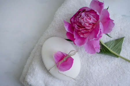 Solid soap, peony flower on a light backgroundの写真素材