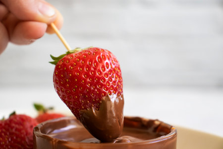 Fresh strawberries in chocolate on a light backgroundの写真素材