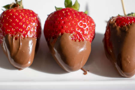 Fresh strawberries in chocolate on a light backgroundの写真素材