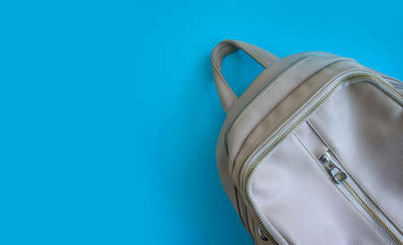 Empty light backpack on a colored backgroundの写真素材