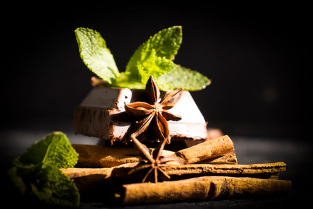Black chocolate, mint leaf on a dark backgroundの写真素材