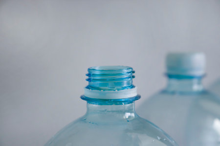 Empty plastic bottle blue background